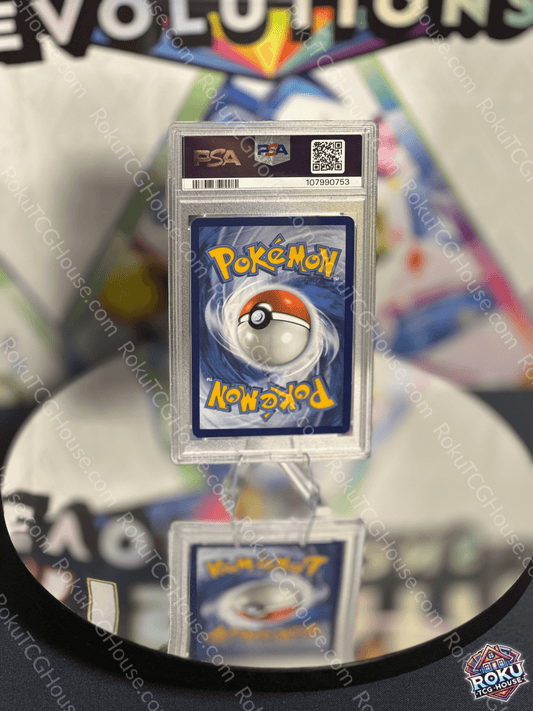 Spheal - Surging Sparks Pokémon Card (PSA 8) displayed on a reflective surface, showcasing its vibrant design.