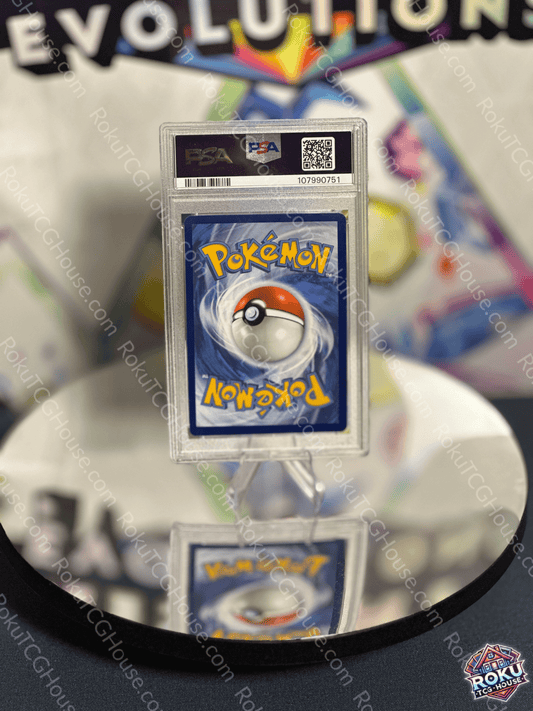 Pikachu EX Pokemon card PSA 9 displayed on a reflective surface, showcasing vibrant artwork from the Surging Sparks set.