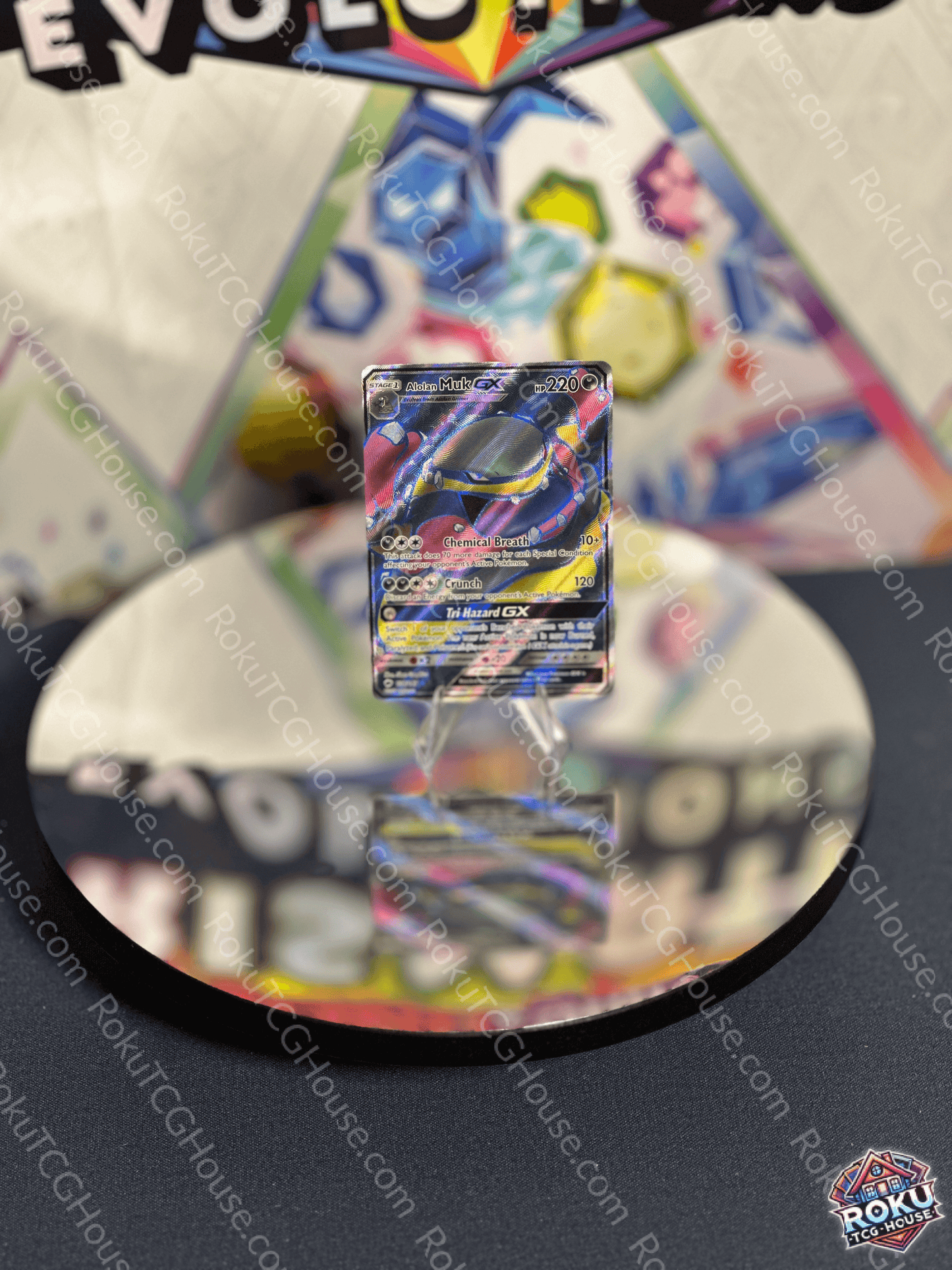 Alolan Muk GX card from Burning Shadows displayed on a reflective surface, showcasing its vibrant artwork.
