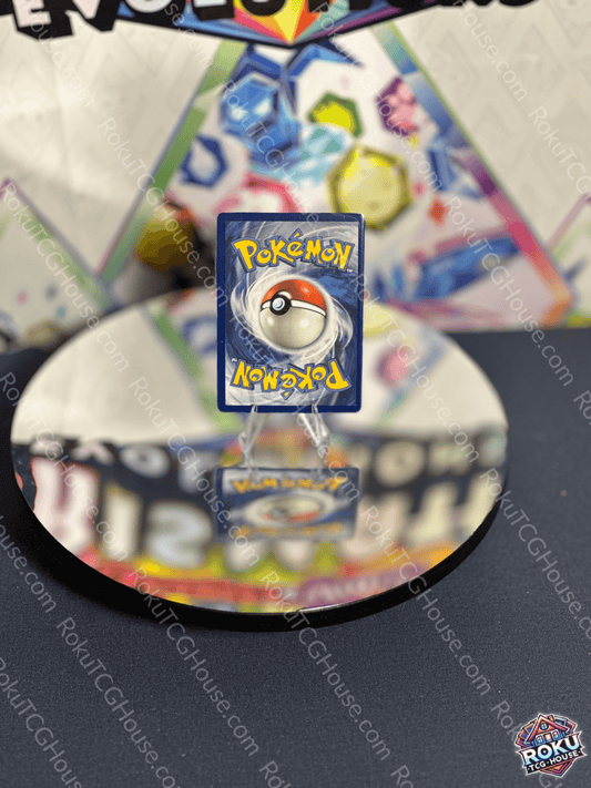 Pokémon card displayed on a mirrored surface, showcasing the iconic Poké Ball design.