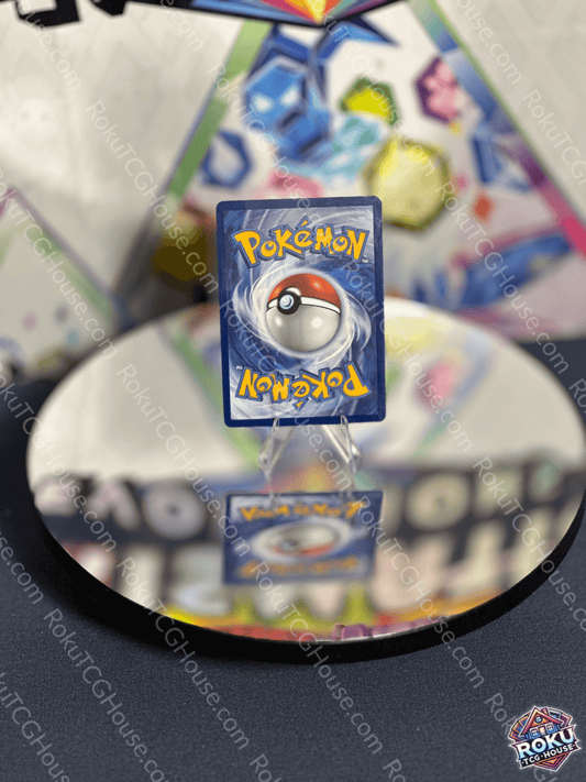 Vibrava Pokemon card Surging Sparks displayed on a reflective surface with colorful background.