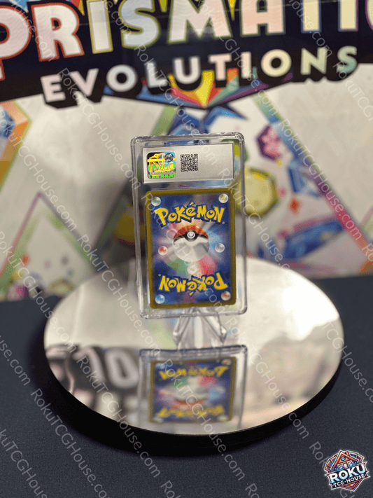 Miltank Pokémon card displayed in a protective case at a collector's event with a reflective surface.