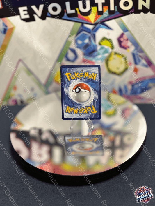 Pokemon card featuring iconic logo reflected on a shiny surface with colorful background from an Evolution set.