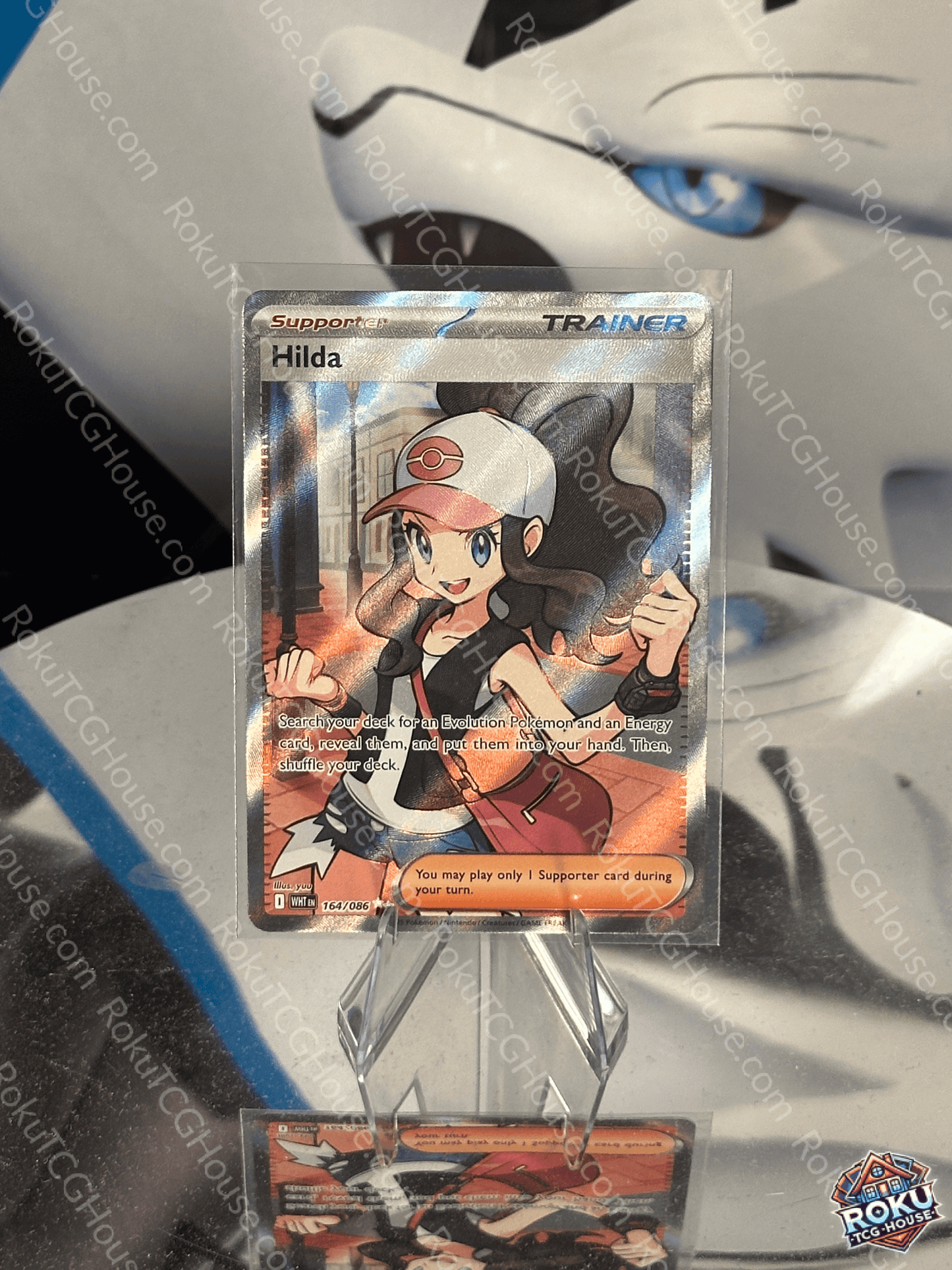 Hilda Pokemon card featuring a white flare design, in near mint condition, displayed prominently.