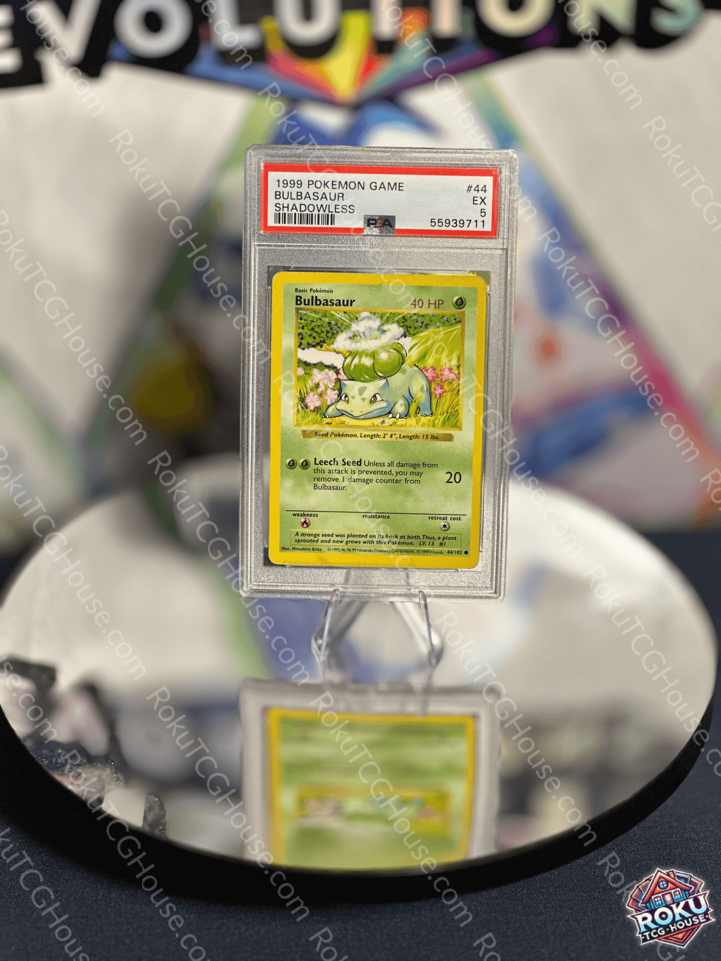 Bulbasaur Shadowless Base Set Pokemon Card PSA 5 displayed on a reflective surface for collectors.