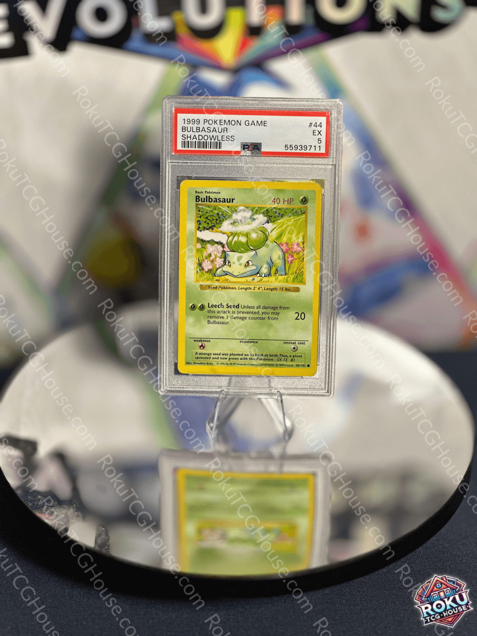 Bulbasaur Shadowless Base Set Pokemon Card PSA 5 displayed on a reflective surface for collectors.