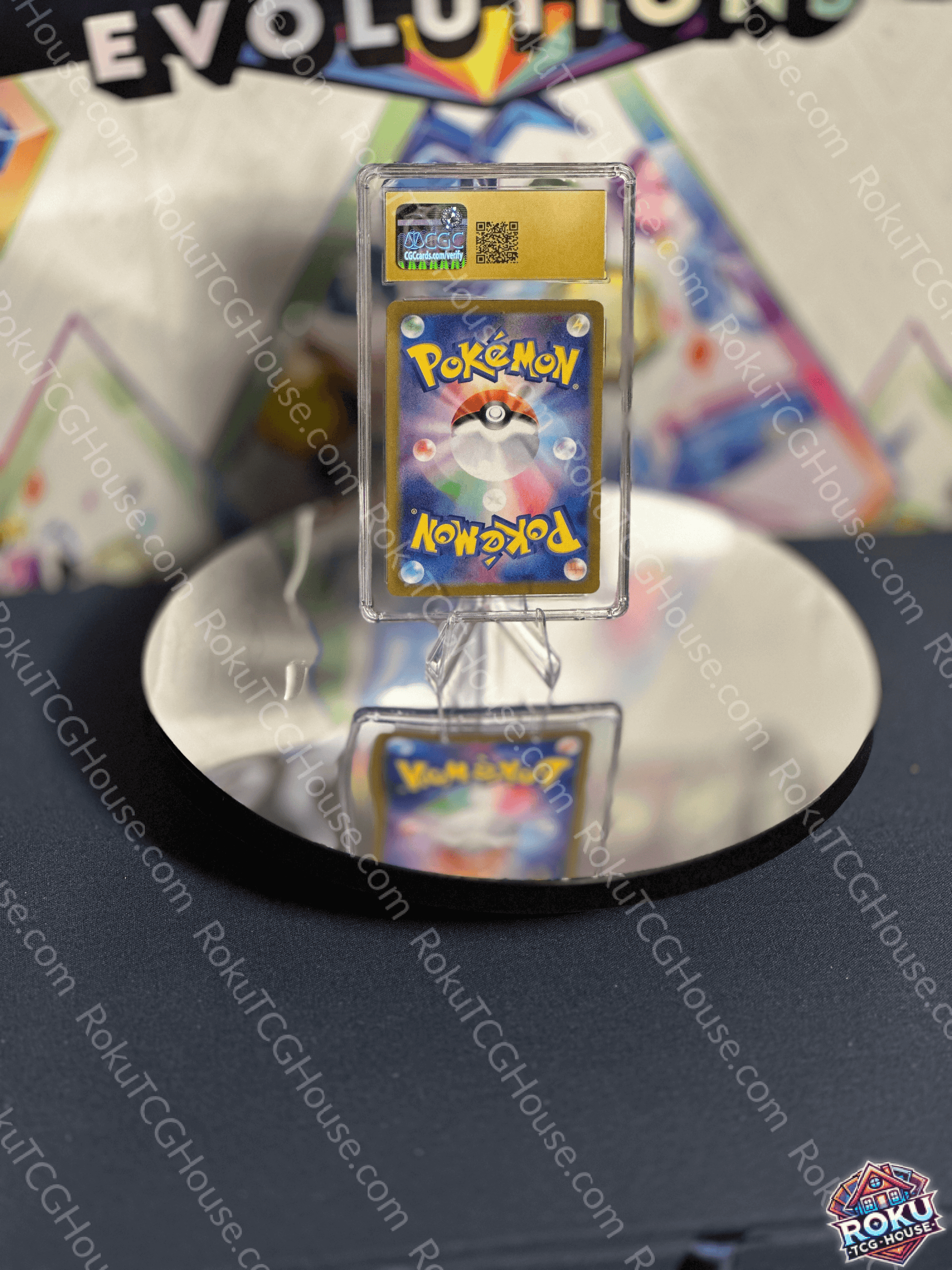 Close-up of a graded Pokémon card displayed on a reflective surface, showcasing vibrant artwork and high quality.
