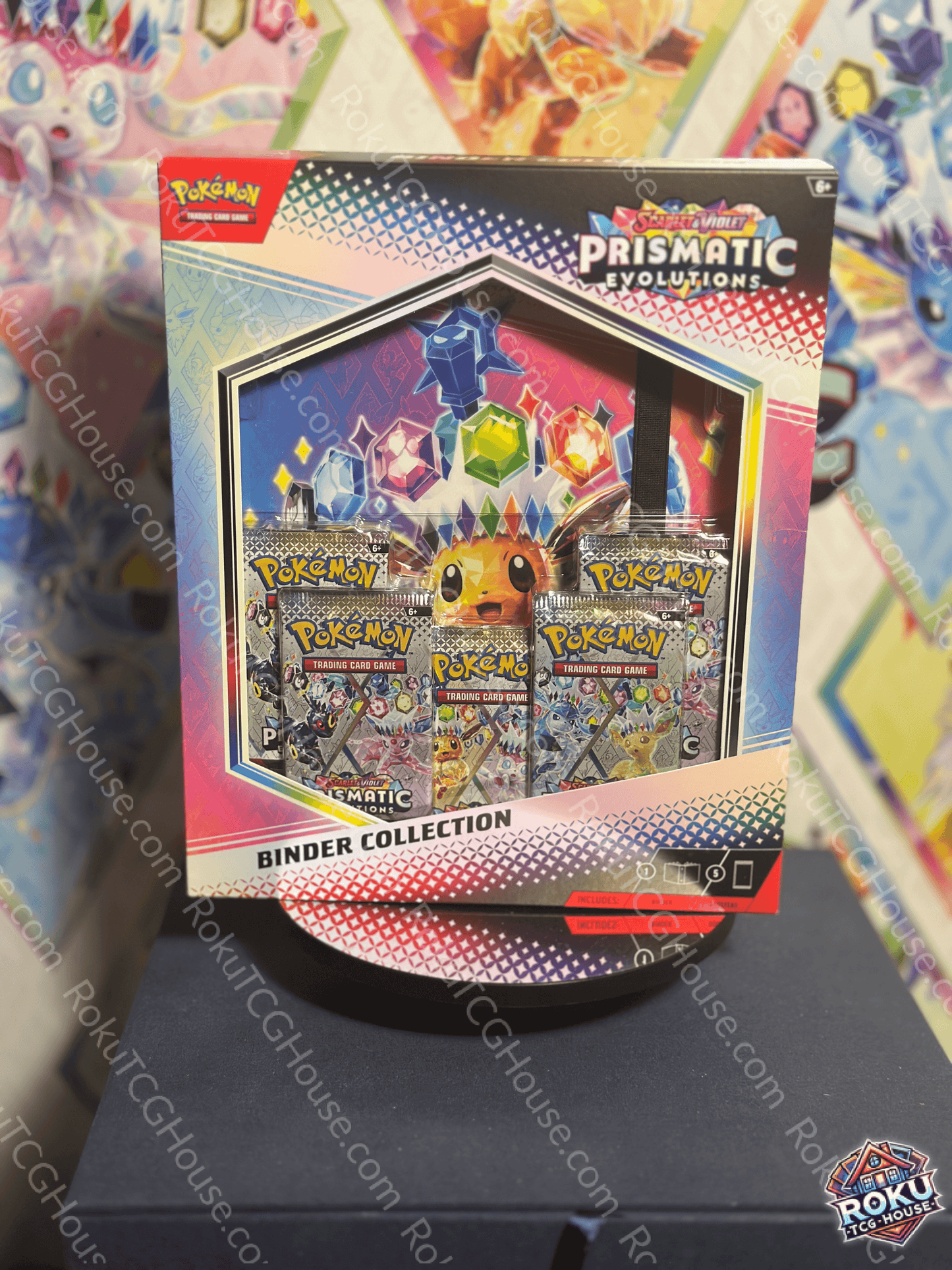 Pokémon Prismatic Evolutions Binder Collection displayed with vibrant artwork and card packs.