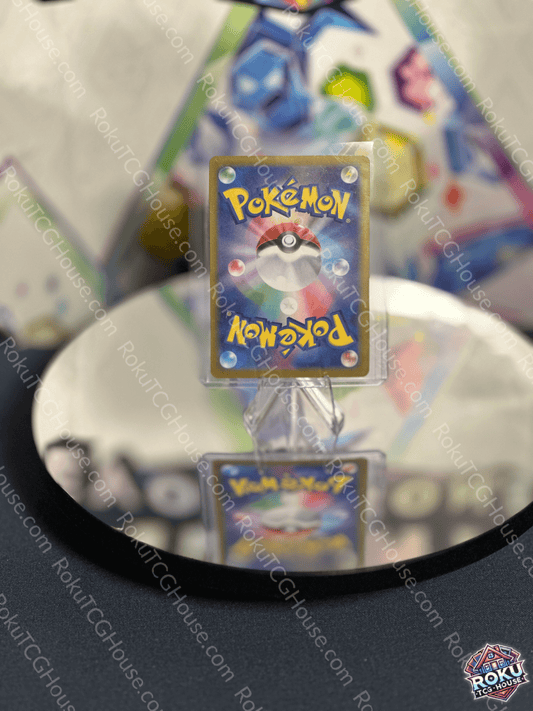 Pikachu EX Terastal Festival Pokemon card displayed on a reflective surface, showcasing vibrant colors and detailed design.