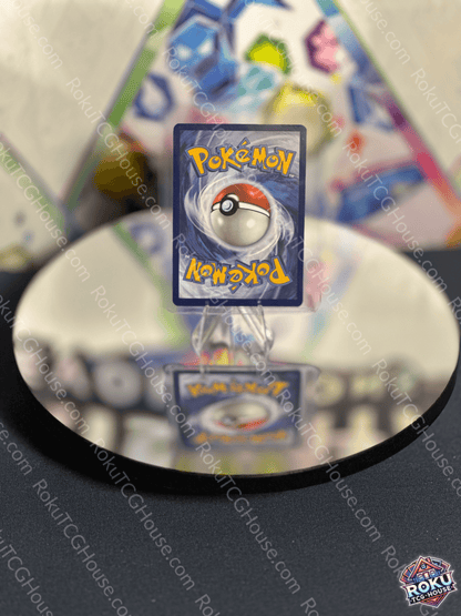 Pikachu Pokemon card displayed on a reflective surface with vibrant colors and iconic Pokeball design.