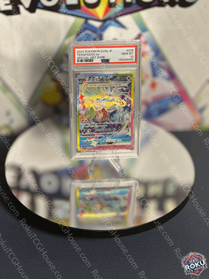 Terapagos EX Pokemon card from Terastal Festival, graded PSA 10, displayed on a mirrored surface.