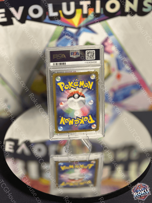 Dragapult EX Terastal Festival Pokemon card graded PSA 10 displayed on a reflective surface.