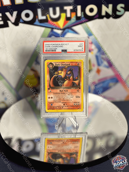 Dark Charizard Pokemon card from Team Rocket 1st Edition, graded PSA 9, displayed in a protective case.