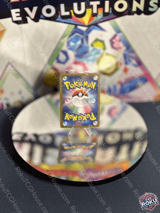 Reflection of a Pokémon card on a mirrored surface, with a colorful Evolutions backdrop.