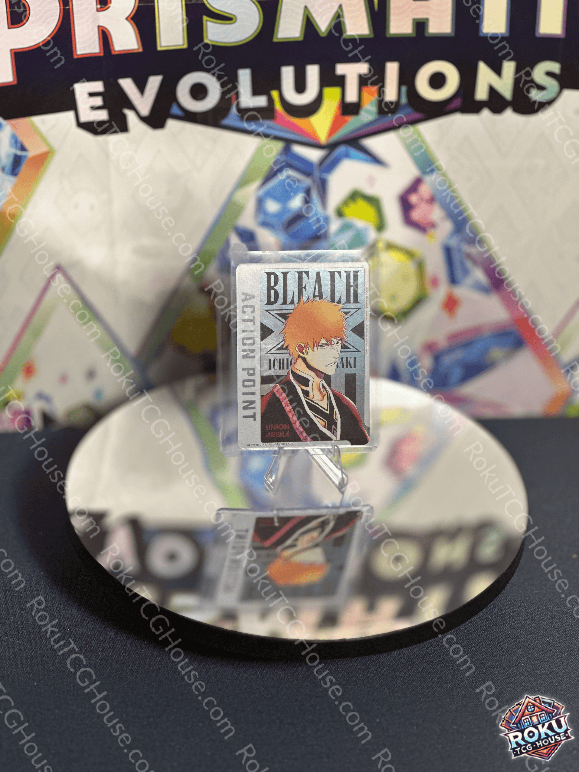 Ichigo Kurosaki Action Point card from Bleach series on a reflective surface, showcasing vibrant trading card design.