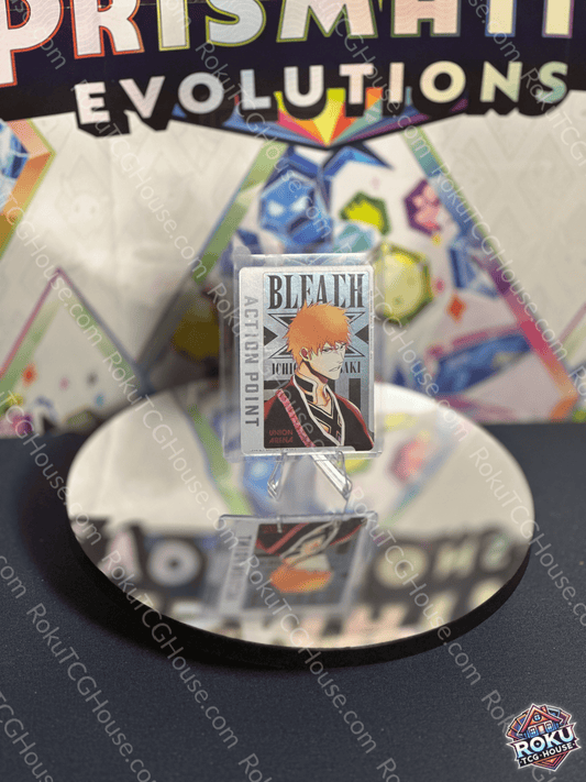 Ichigo Kurosaki Action Point card from Bleach series on a reflective surface, showcasing vibrant trading card design.