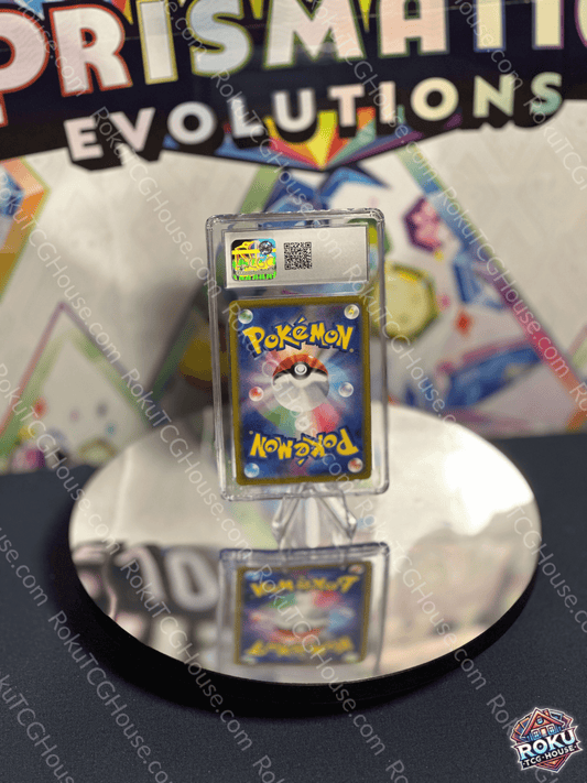 Miltank Pokémon card displayed in a protective case at a collector's event with a reflective surface.