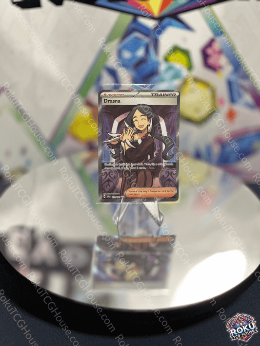Drasna Surging Sparks Pokemon card displayed on a reflective surface, showcasing elegant artwork and design.