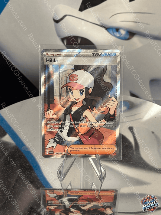Hilda Pokemon card featuring a white flare design, in near mint condition, displayed prominently.