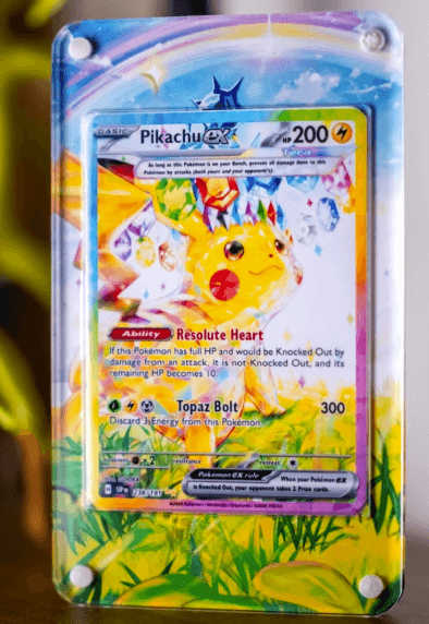 Pikachu EX card displayed with GeeksStop art extender, featuring vibrant colors and detailed artwork.