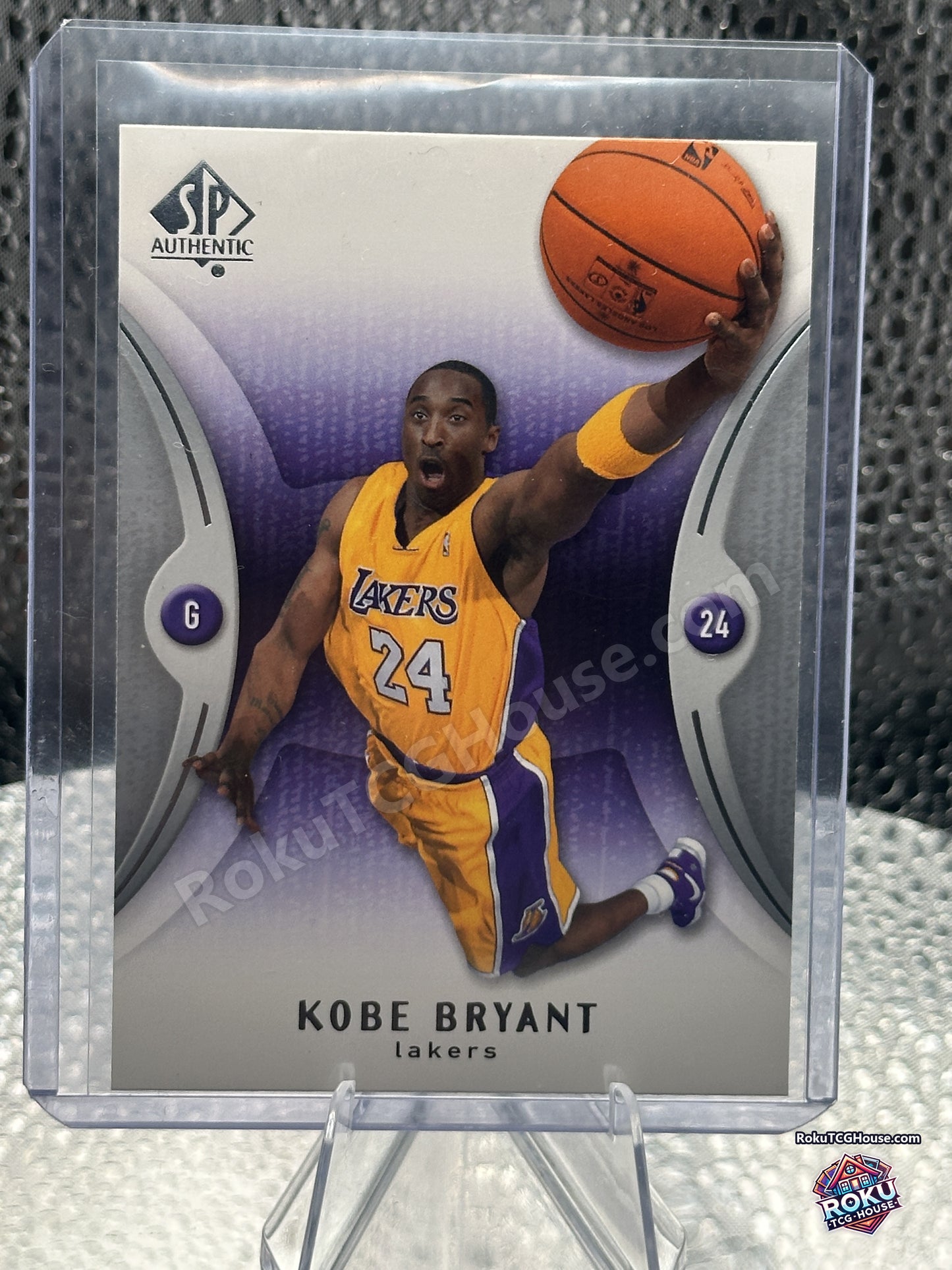 Front of the 2006-07 SP Authentic Kobe Bryant card number 37, Lakers guard rising for a one-handed finish