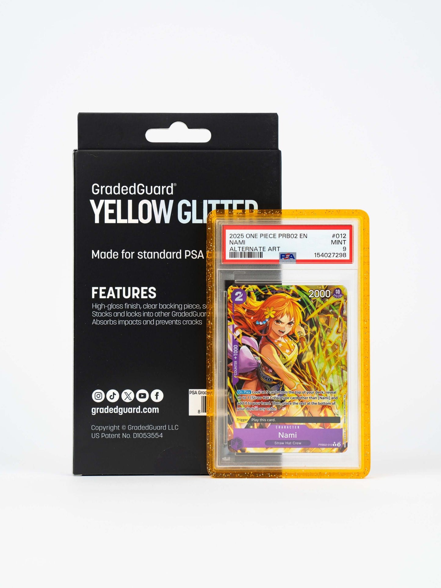 GradedGuard Yellow Glitter retail box beside a case holding a PSA graded One Piece Nami slab